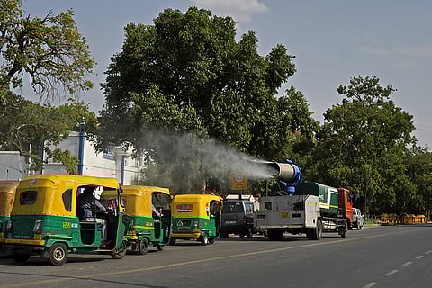 A vehicle sprays water in Delhi